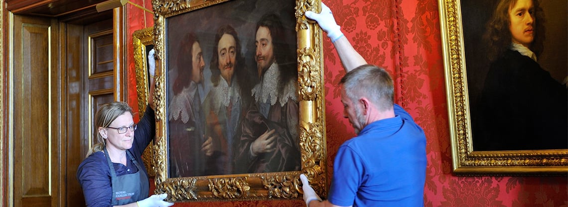 Painting being moved by art handlers